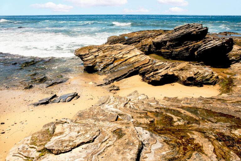 Rugged rock formations along the coast at Newport Beach, California, showcasing natural beauty.