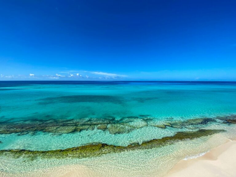 Breathtaking view of a tropical beach with crystal clear turquoise waters and pristine sandy shore.
