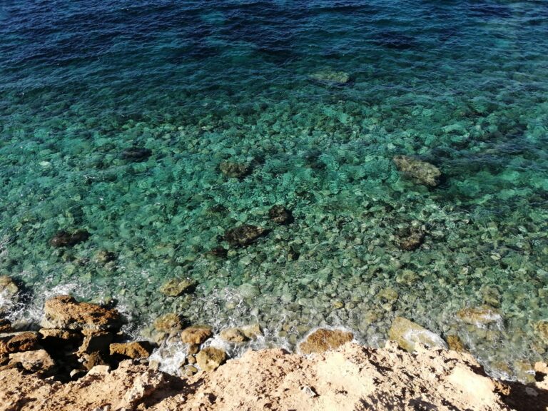 A beautiful rocky coast with clear turquoise waters, perfect for nature and travel enthusiasts.