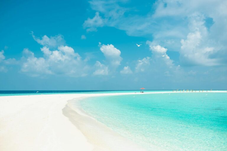 Experience tranquility at this pristine tropical beach with turquoise waters and clear skies.