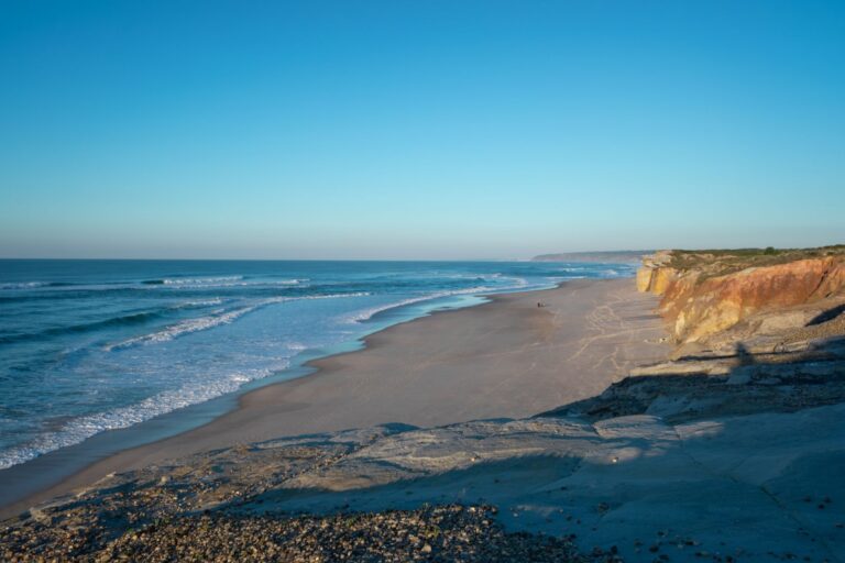 Explore the serene beauty of Praia da Foz's coastline with sandy shores and rugged cliffs.