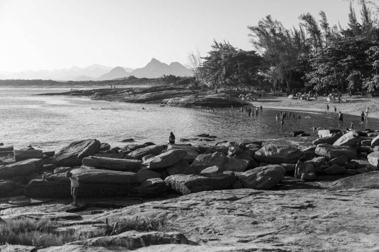 Breathtaking black and white view of a beach with rocky shorelines in Rio de Janeiro, Brazil.