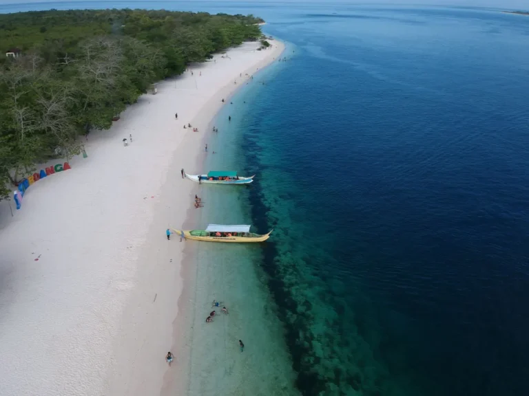 Explore the clear blue waters and white sands of Zamboanga's coastline from above.