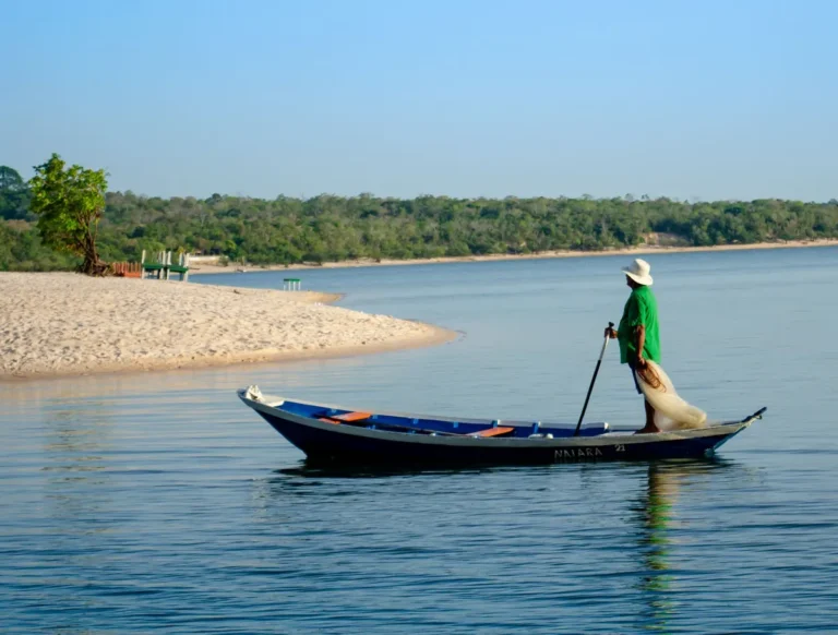 A fisherman in a canoe on a serene river near Alter do Chão, Brazil.