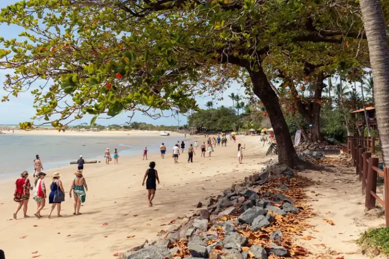 People enjoying a sunny day on the beach at Morro de São Paulo, Bahia, Brazil.